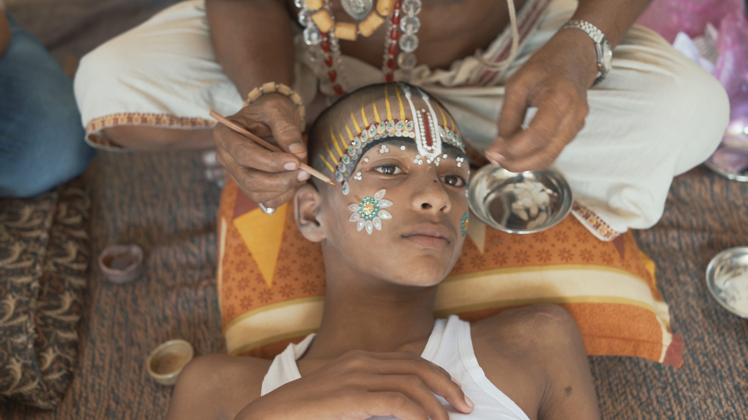 cover image of a child getting his face painted and decorated
