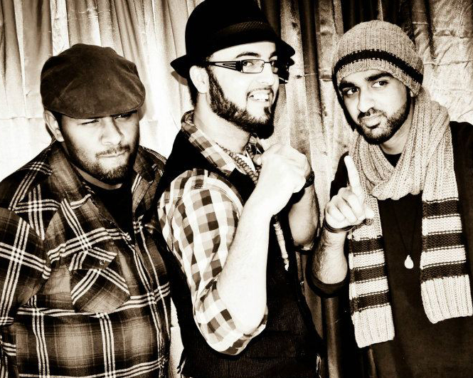 Three men in a black and white in various poses with hats on and layered shirts
