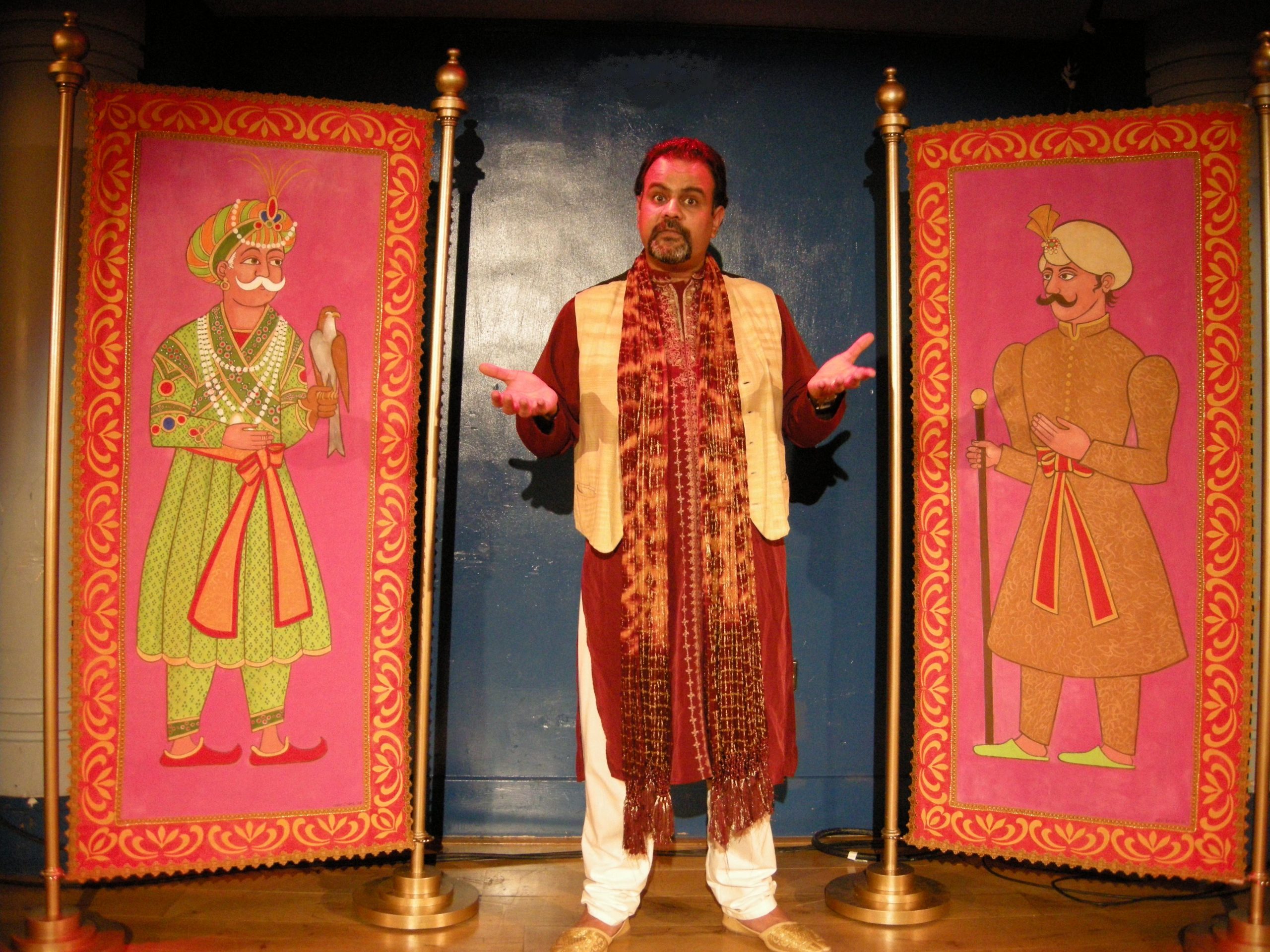 Storytelling workshop and Tale Trail with man in the middle and two tapestries of men in different outfits either sit of him