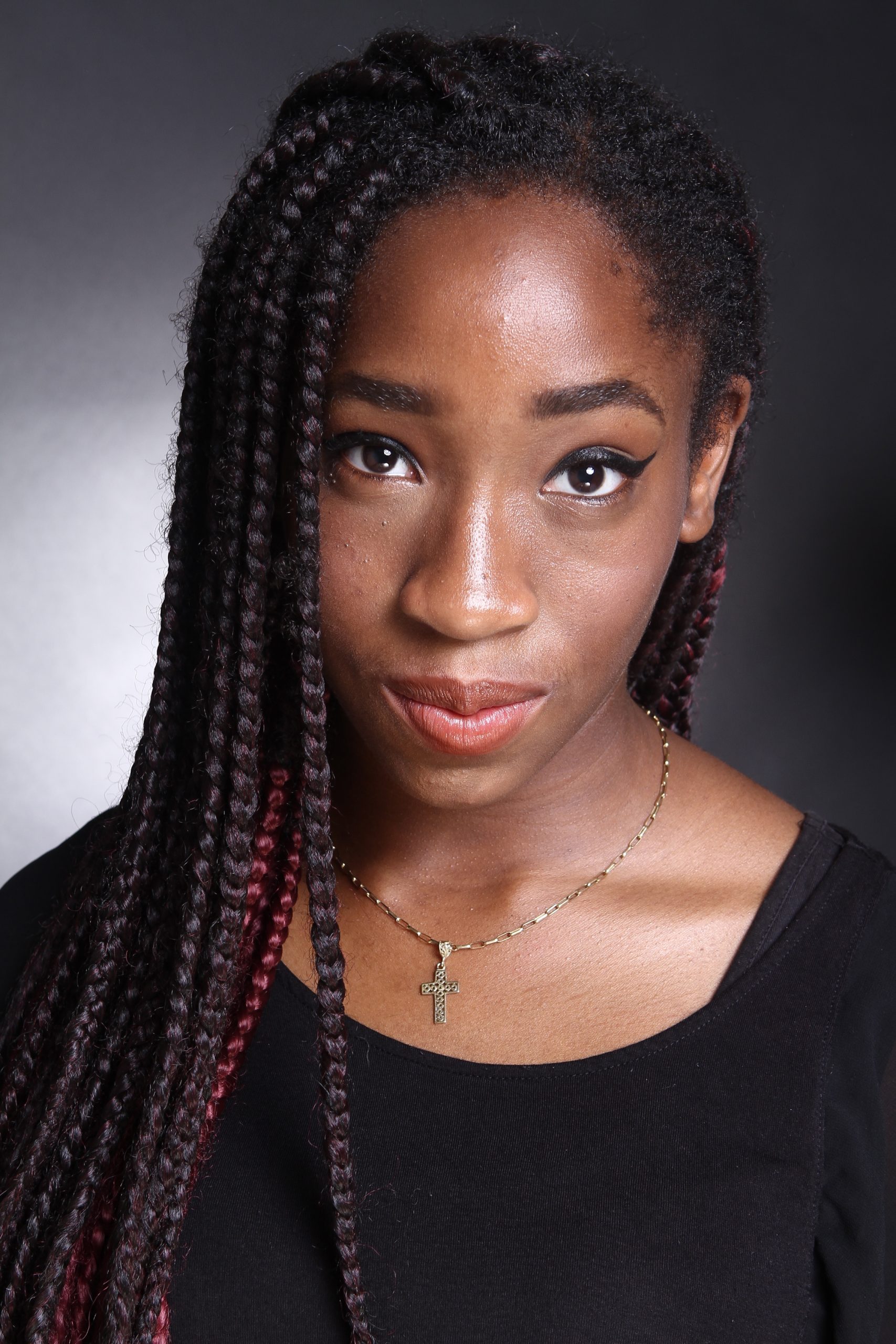 Headshot of a woman in a black top looking at the camera