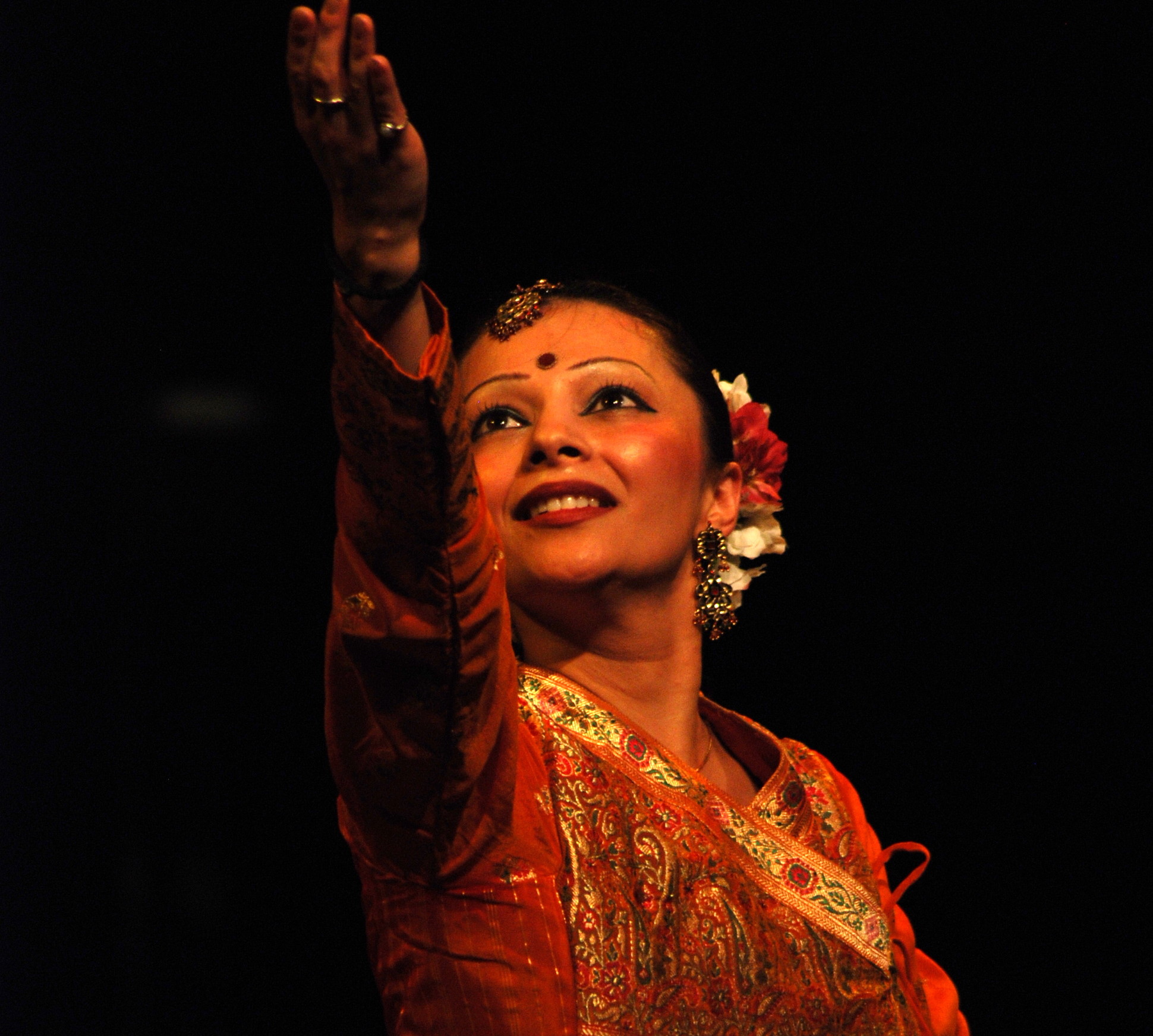 Dancing the Ramayana close up of female dancer smiling and looking up at arm in performance