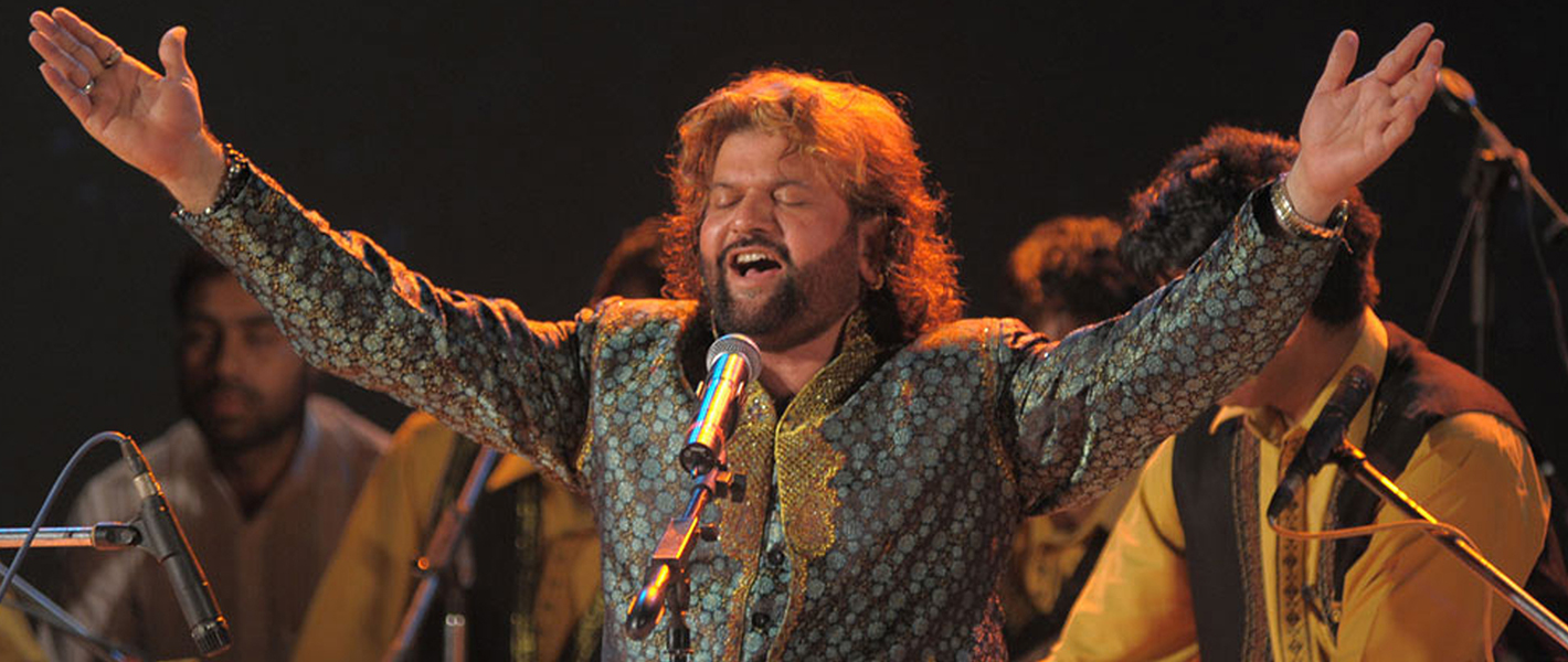 Hans Raj Hans in convert singing in a blue patterned kurta