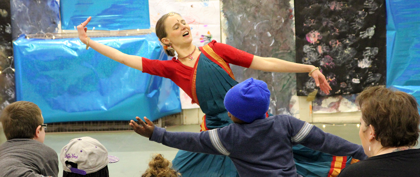 Lori lullaby workshop with children being taught dance by a female artist