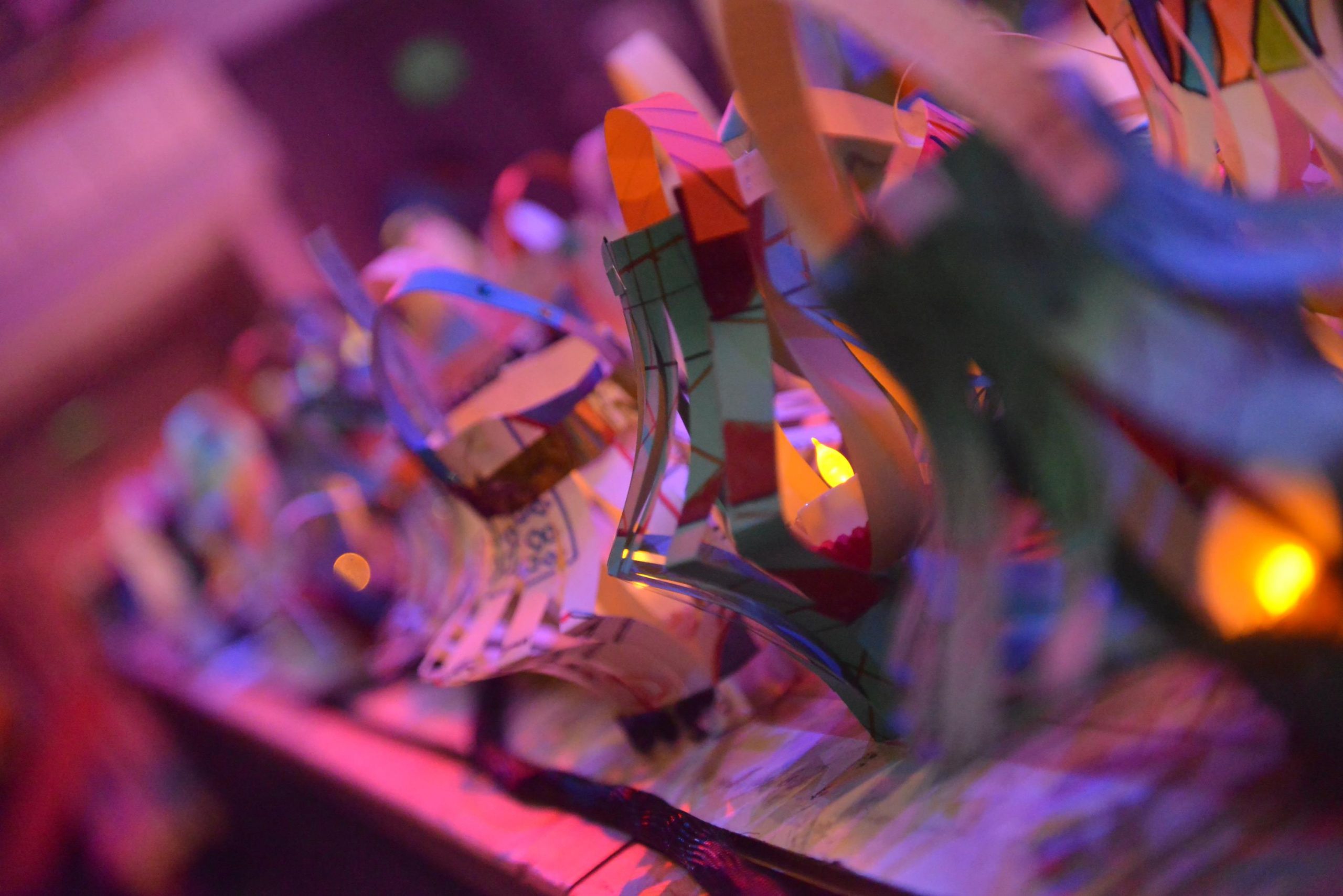 an angled photo of paper lanterns, handmade and decorated with lights inside