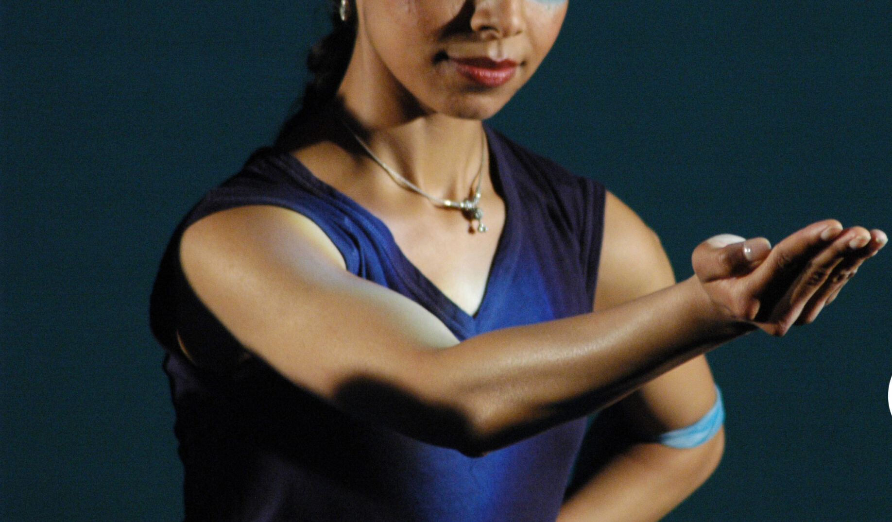 Poised female performer with hard outstretched