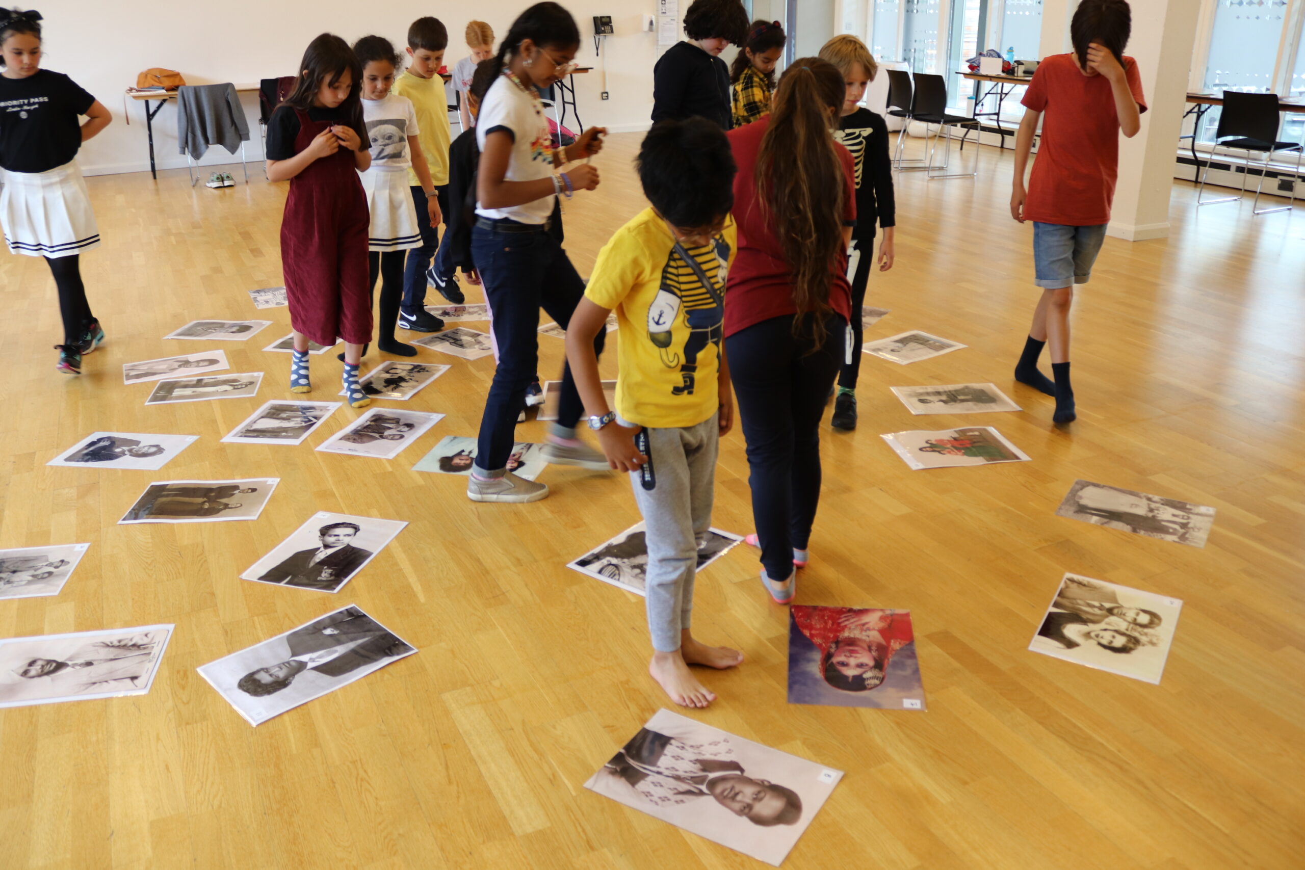 summer school activity with children and portraits on the floor