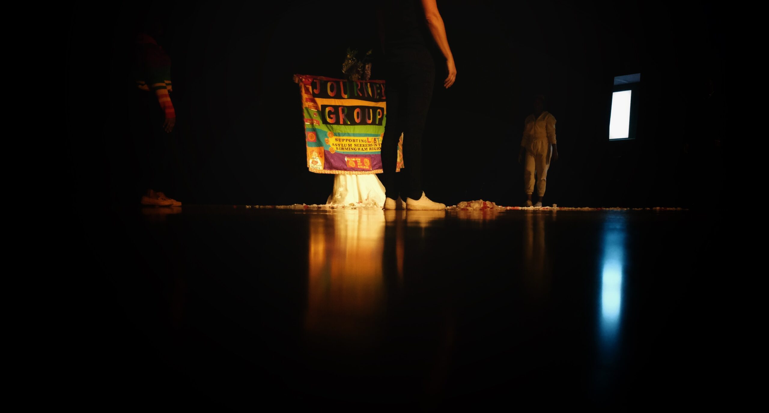 a low light image of a stage with a poster in the background