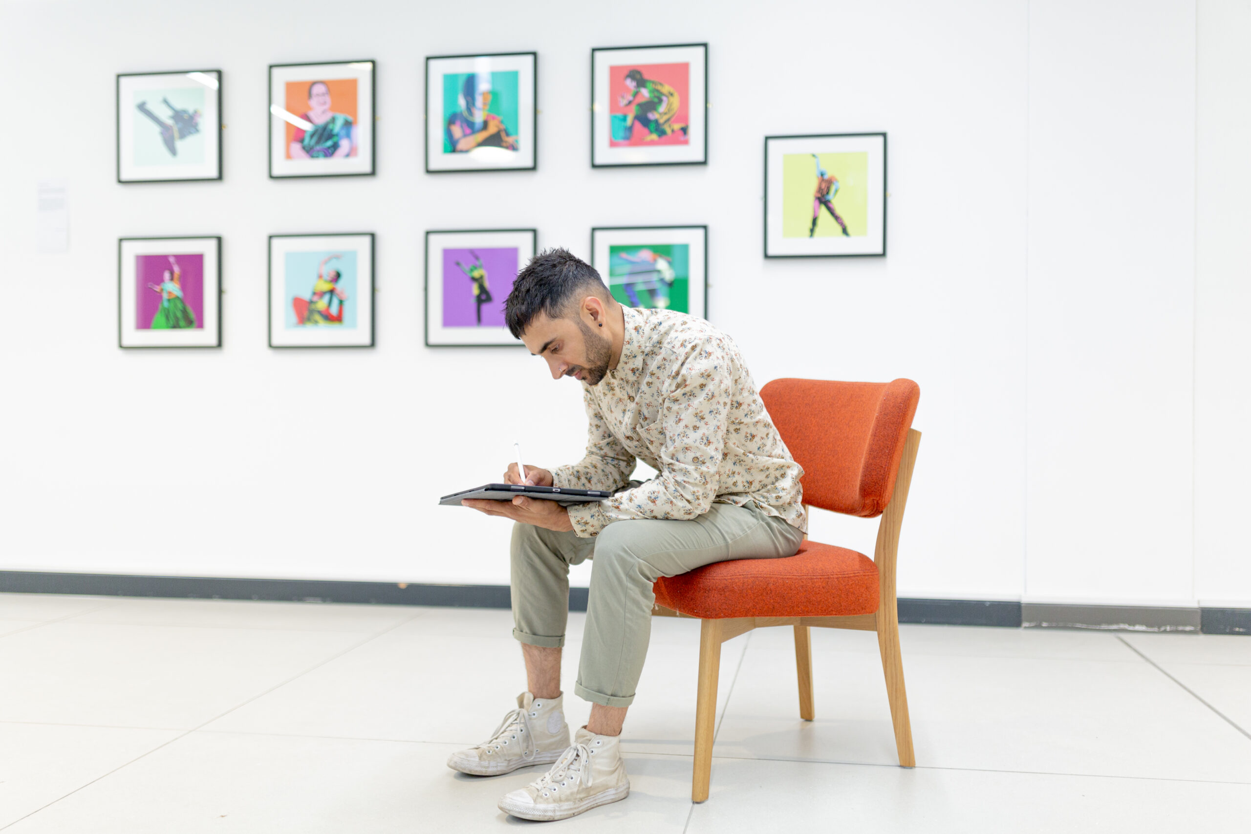 drawing on his tablet with a stylus