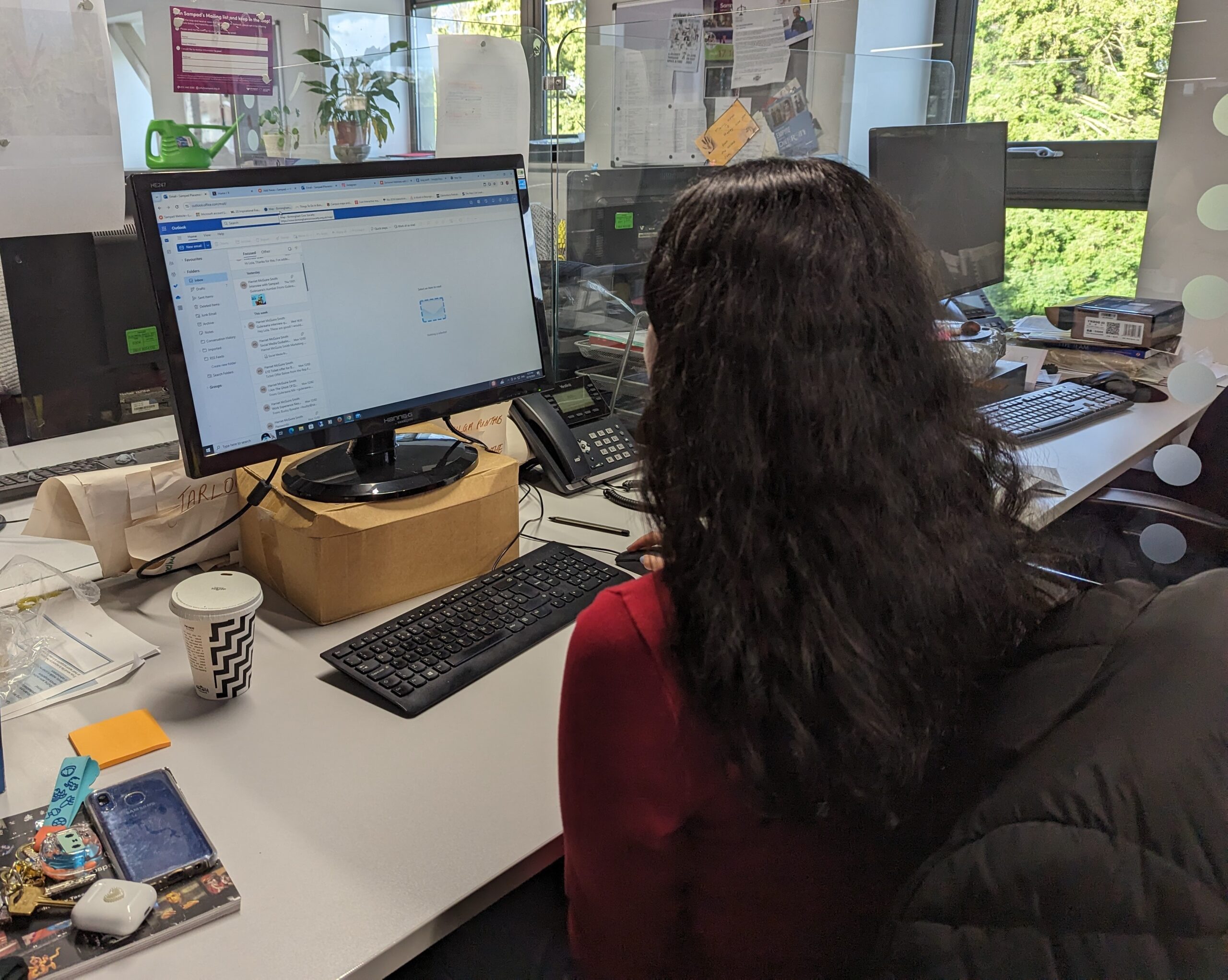 a picture of a woman looking at her computer in the office