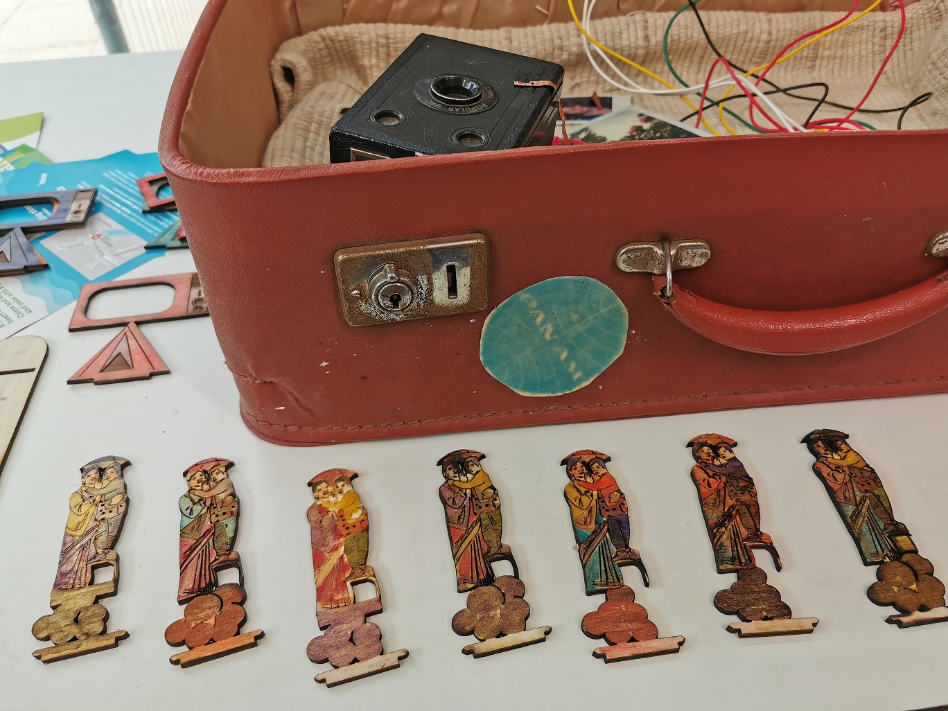 a close up on an open trunk with small painted pieces around it