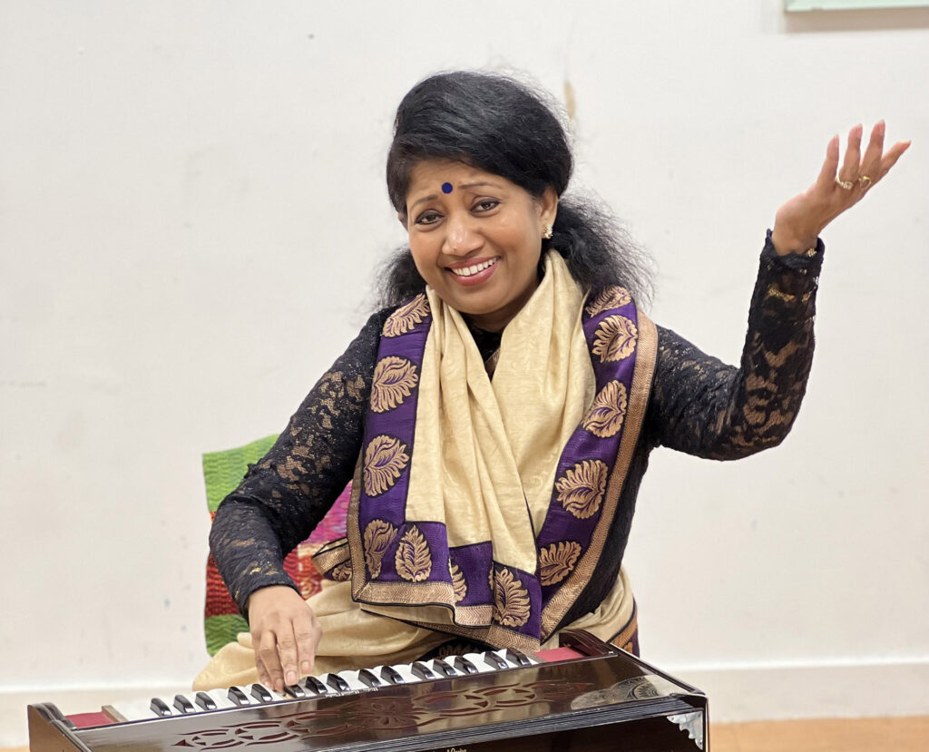Indian musician with harmonium