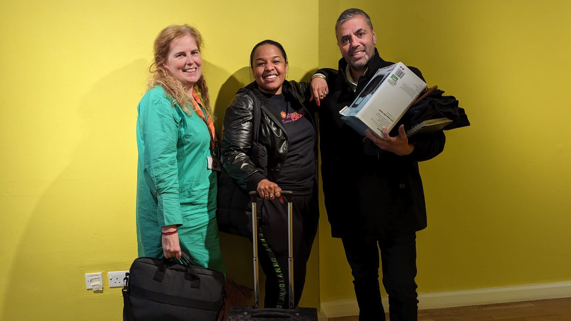 Three members of the sampad associate schools team against a yellow background