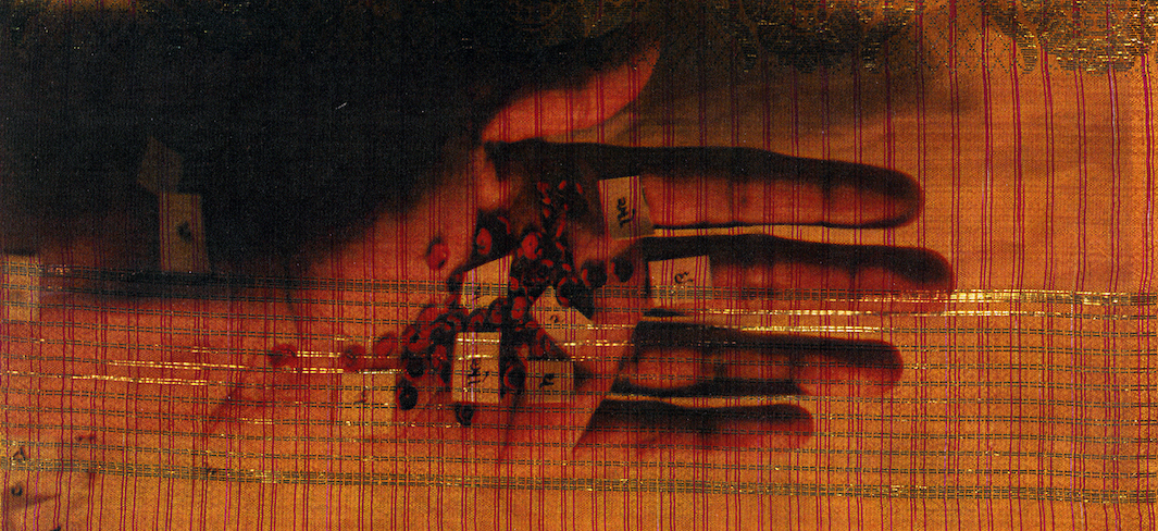 a hand imprinted on fabric with henna and symbols