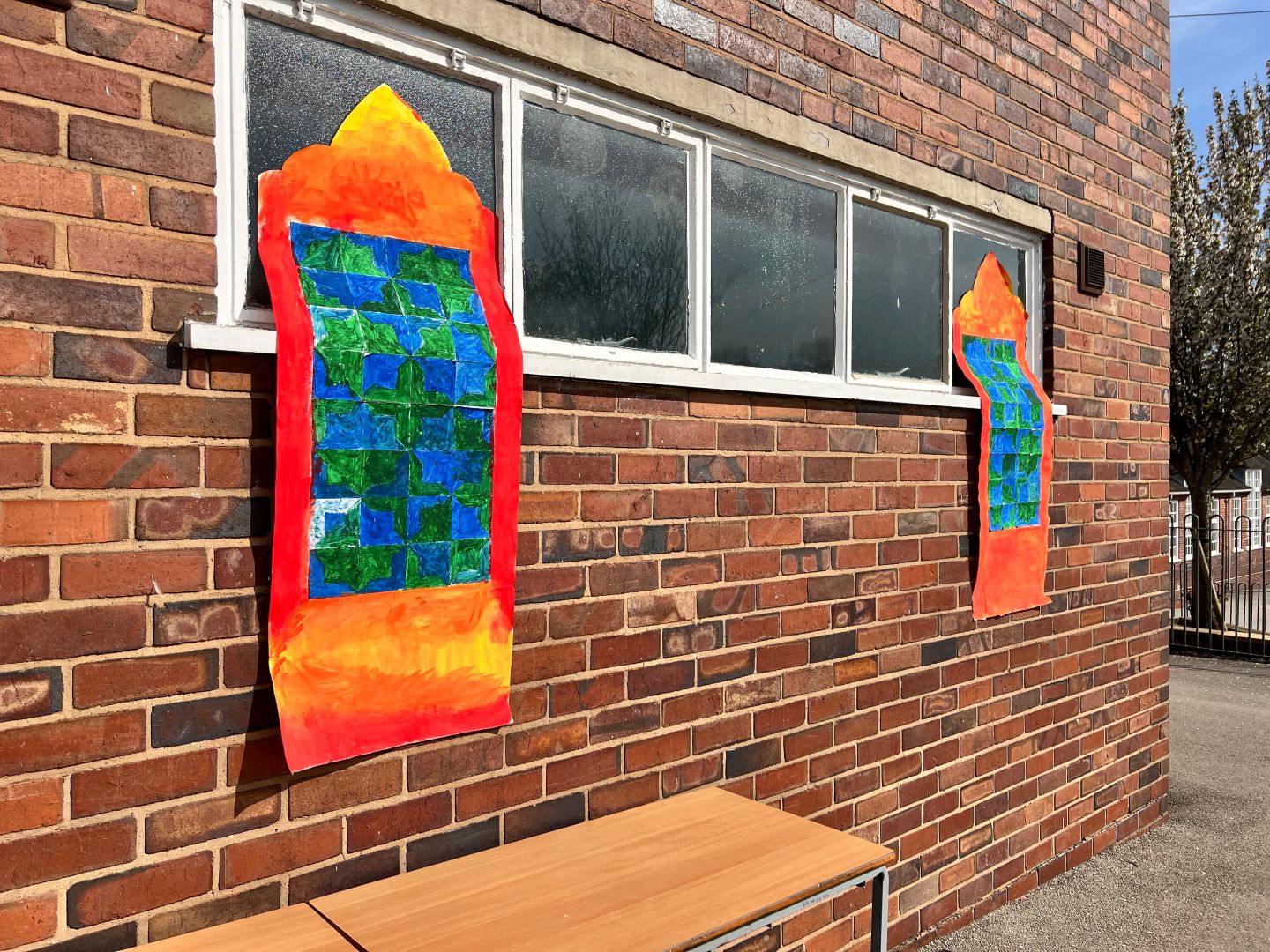 two colourful pieces of artwork frame a window