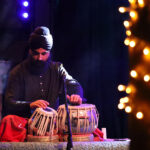 Gurdain Singh playing tabla on stage