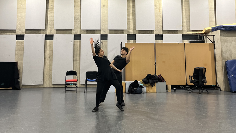 Male and Female performers dancing in a rehearsal studio